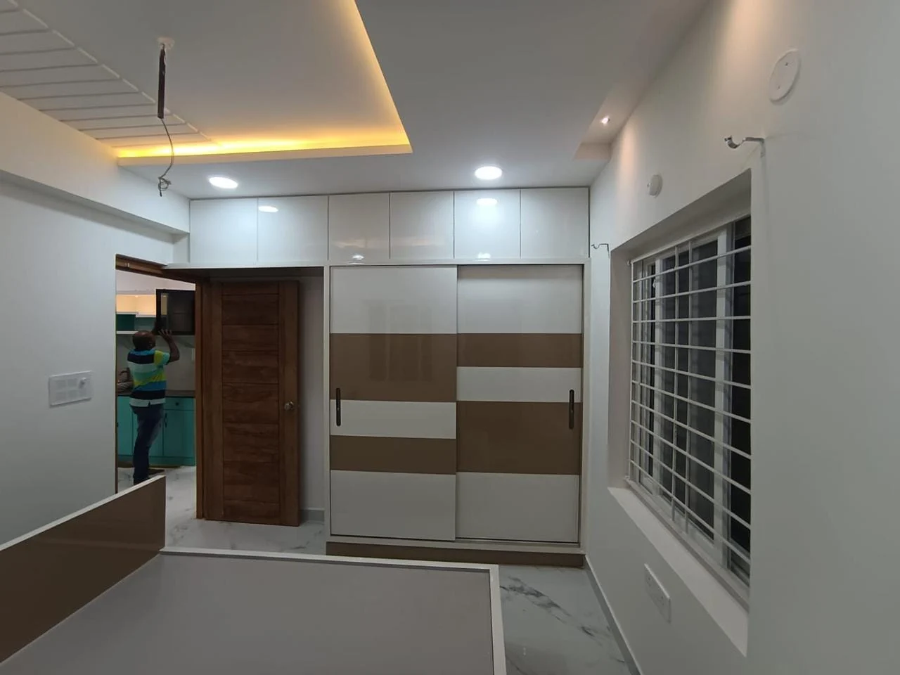 Client bedroom with customised wardrobes and integrated ceiling lighting